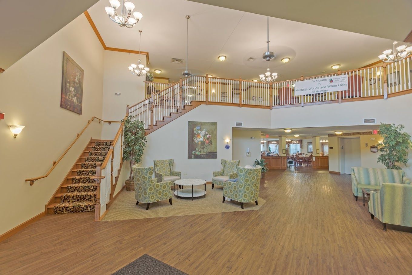 Heritage Woods of Huntley, assisted living in Huntley, IL — Elegant lobby with seating and staircase in senior living facility