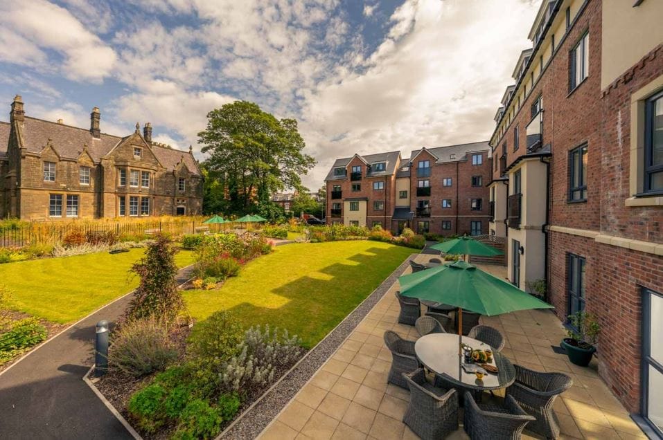 Outdoor garden area with seating and greenery
