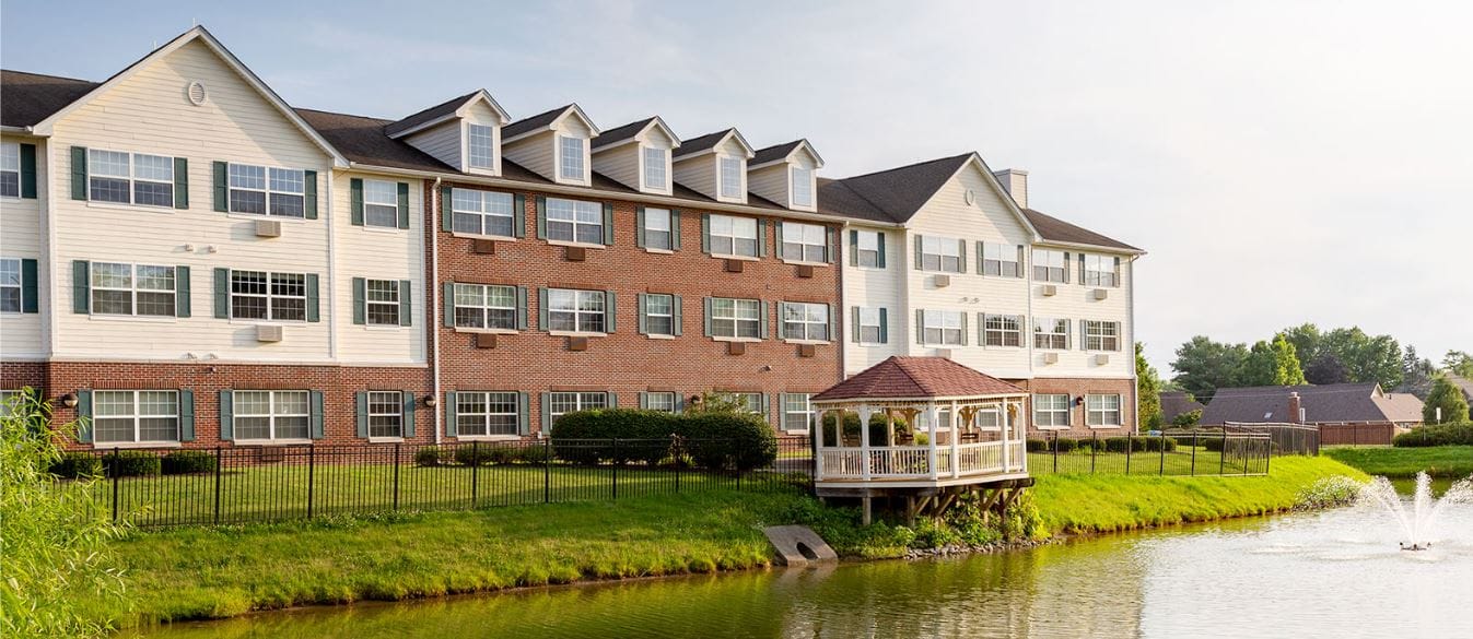 Exterior view of the facility near a pond