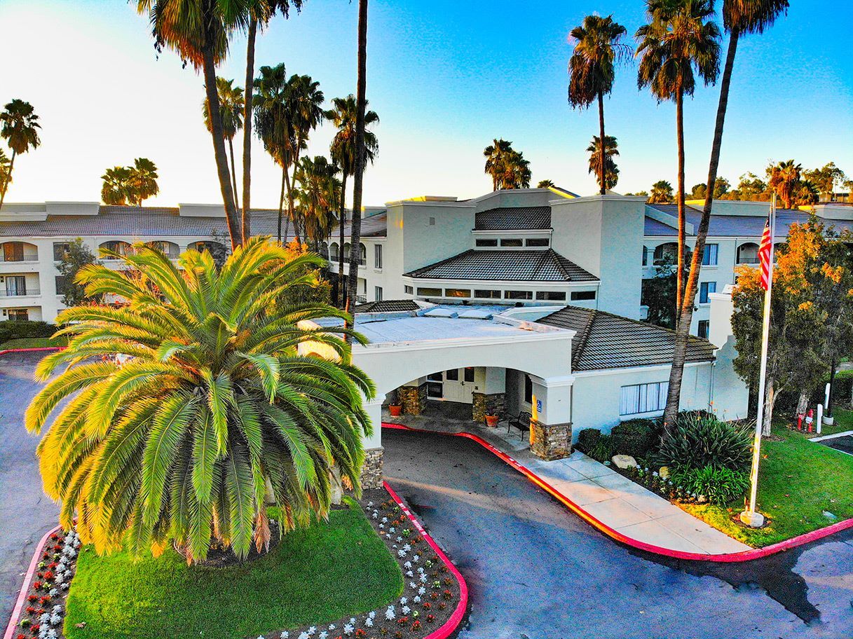 Exterior view of the facility with palm trees