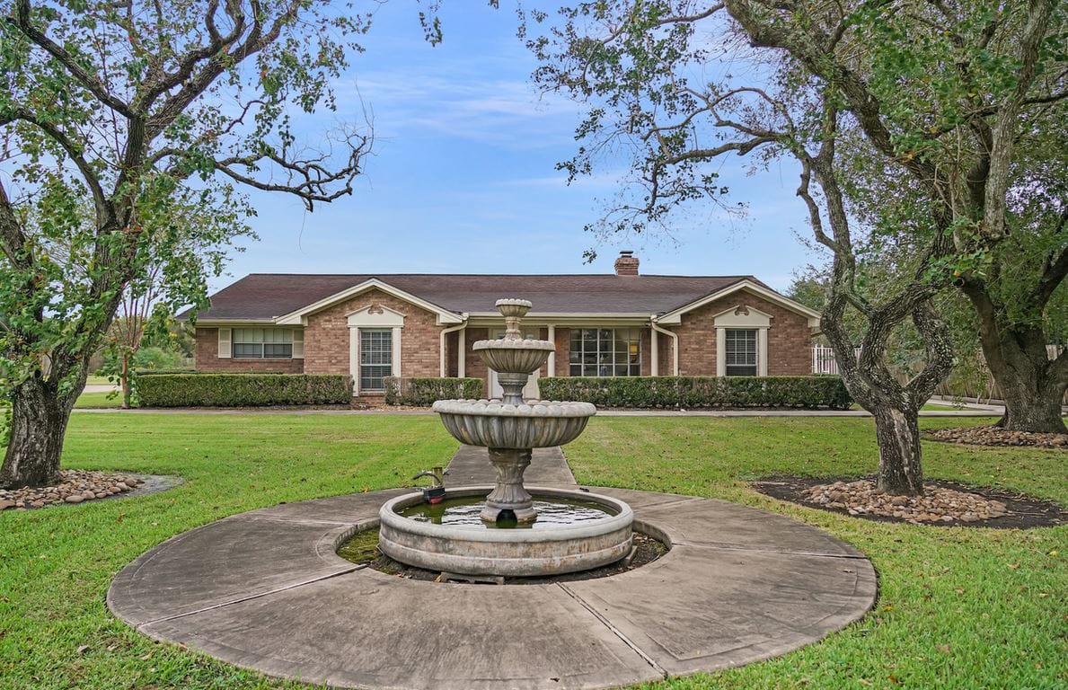 Exterior view of the facility with a fountain and garden
