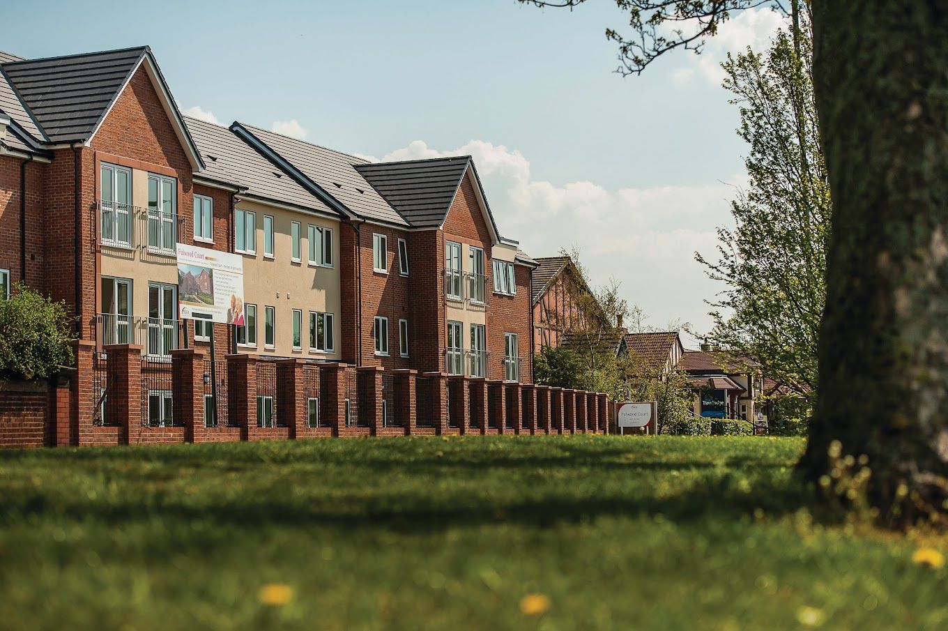 Exterior view of assisted living facility surrounded by grass