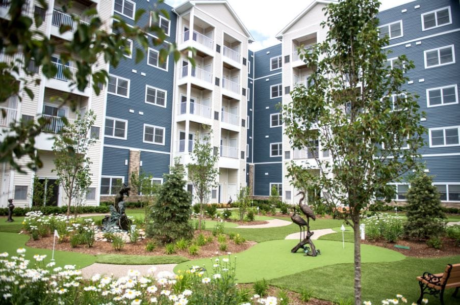 A landscaped garden area with sculptures and buildings