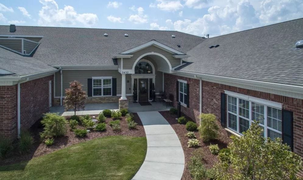 Entrance of a senior living facility with landscaped pathway