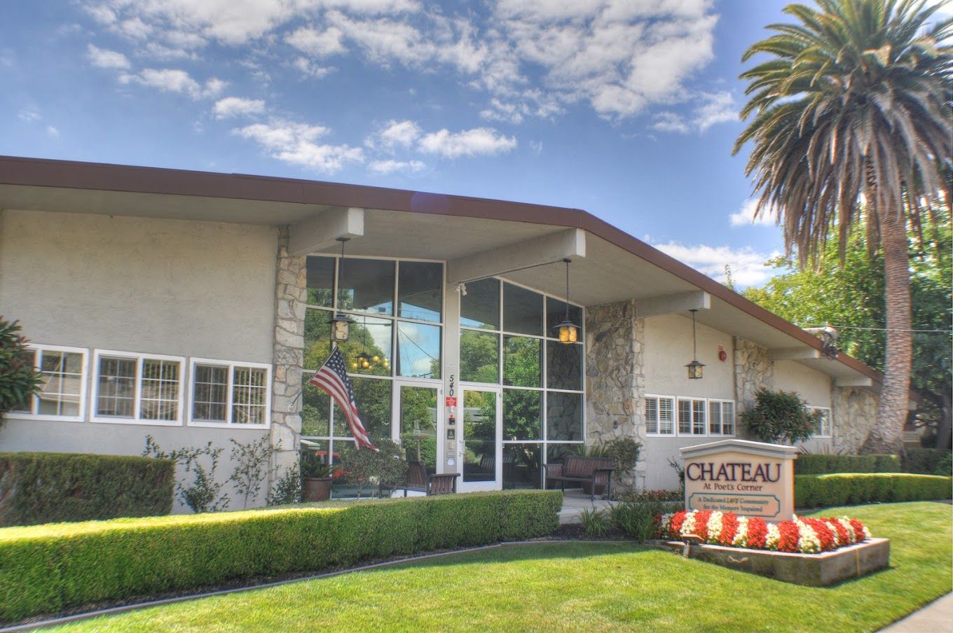 Exterior view of a senior living facility with landscaping