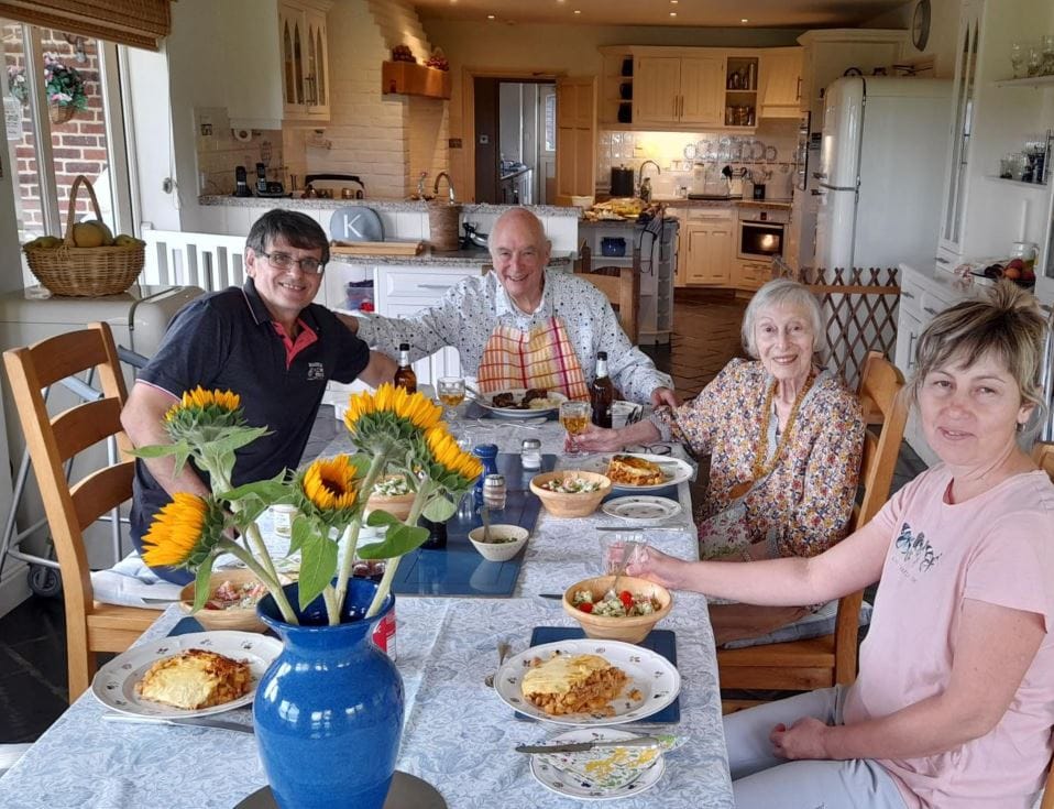 Residents and staff enjoying a meal together in a dining area