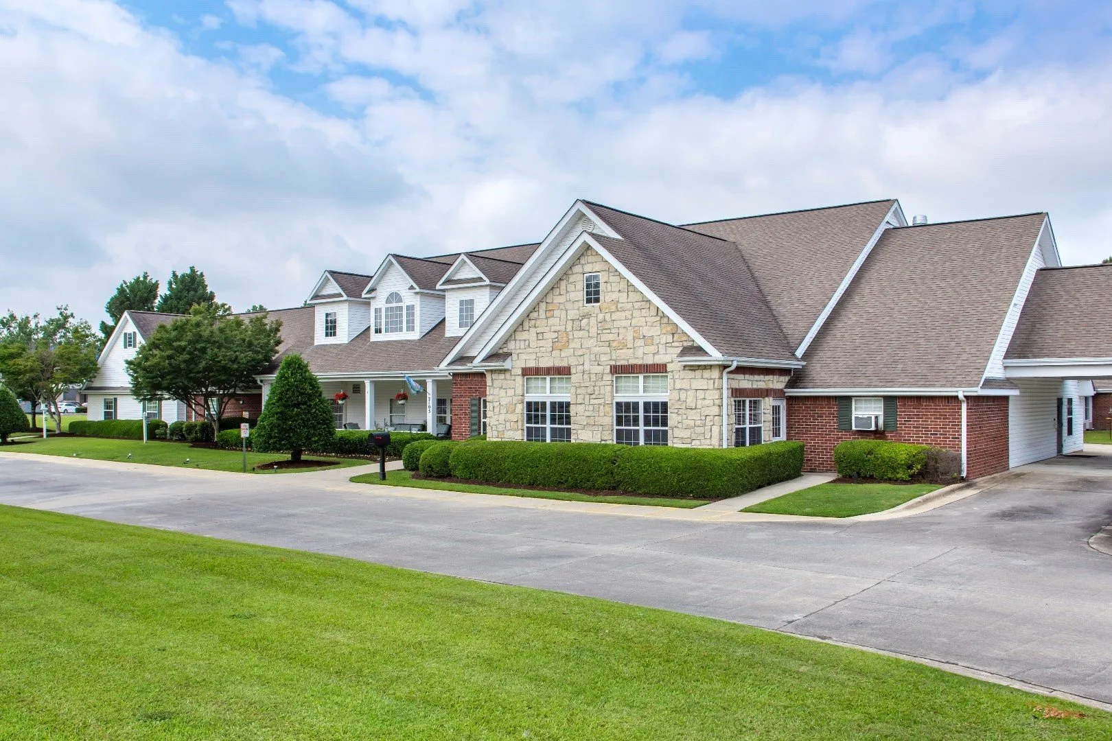 Exterior view of a senior living facility with landscaping