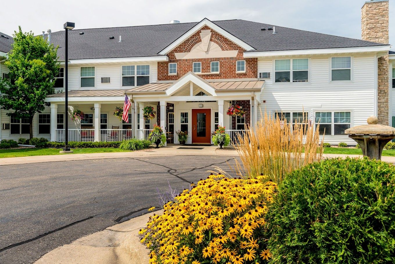 Exterior view of a senior living facility with vibrant flowers