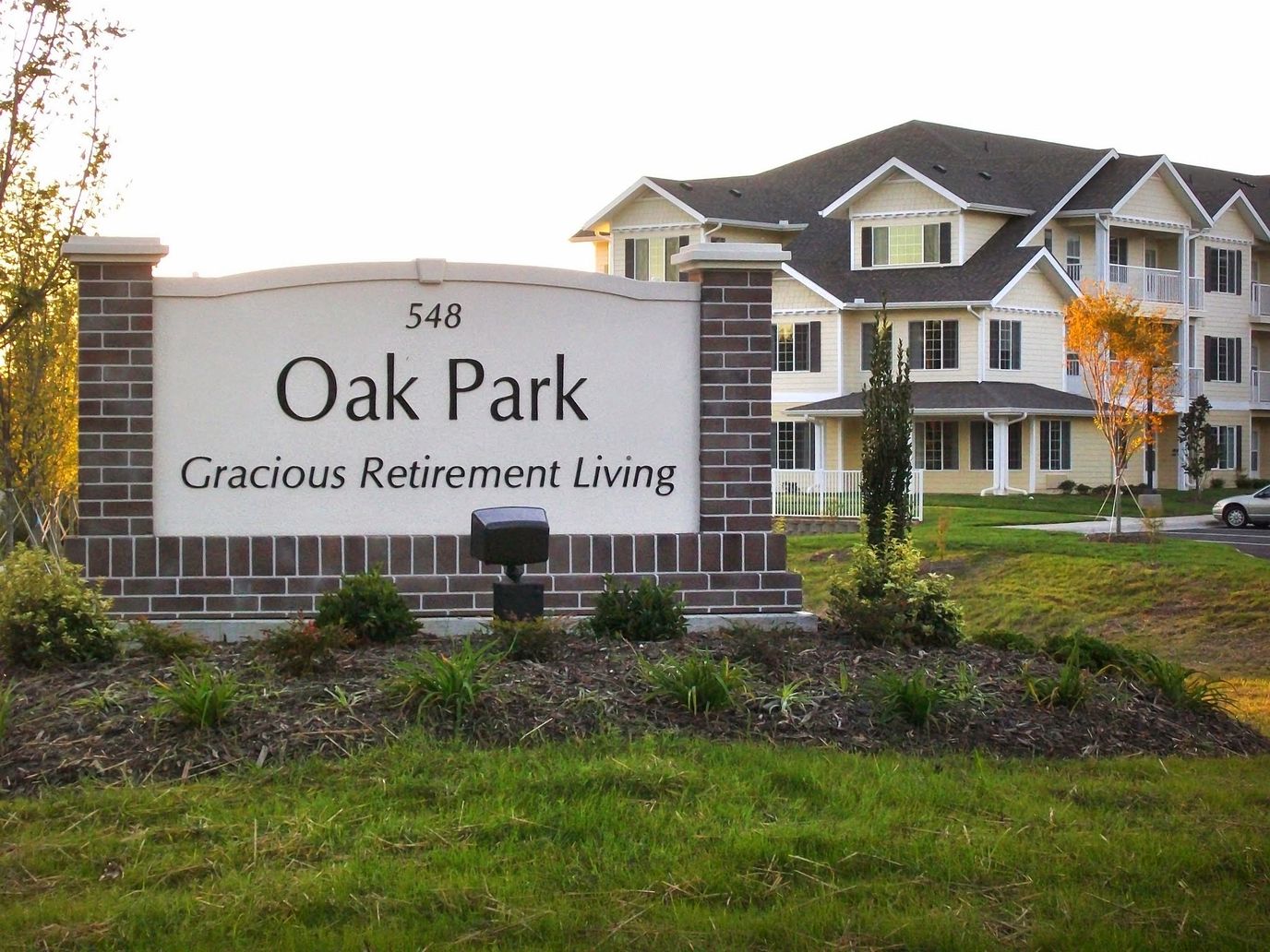 Sign for Oak Park Retirement Living with a building in the background