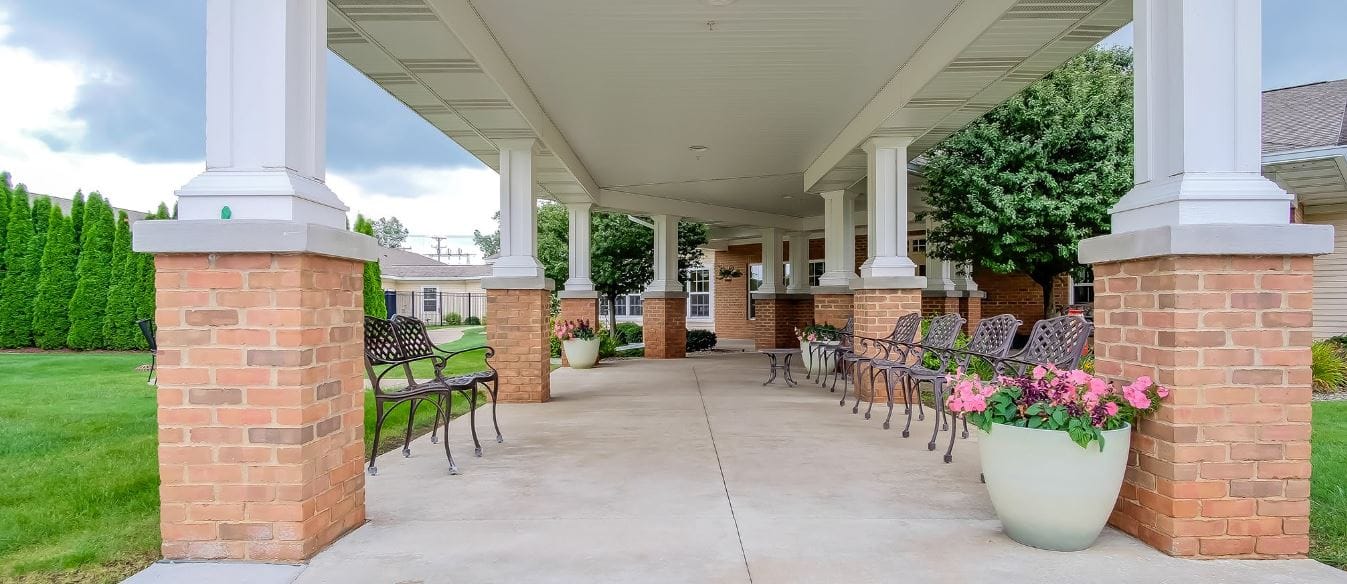 Outdoor seating area with benches and flower pots