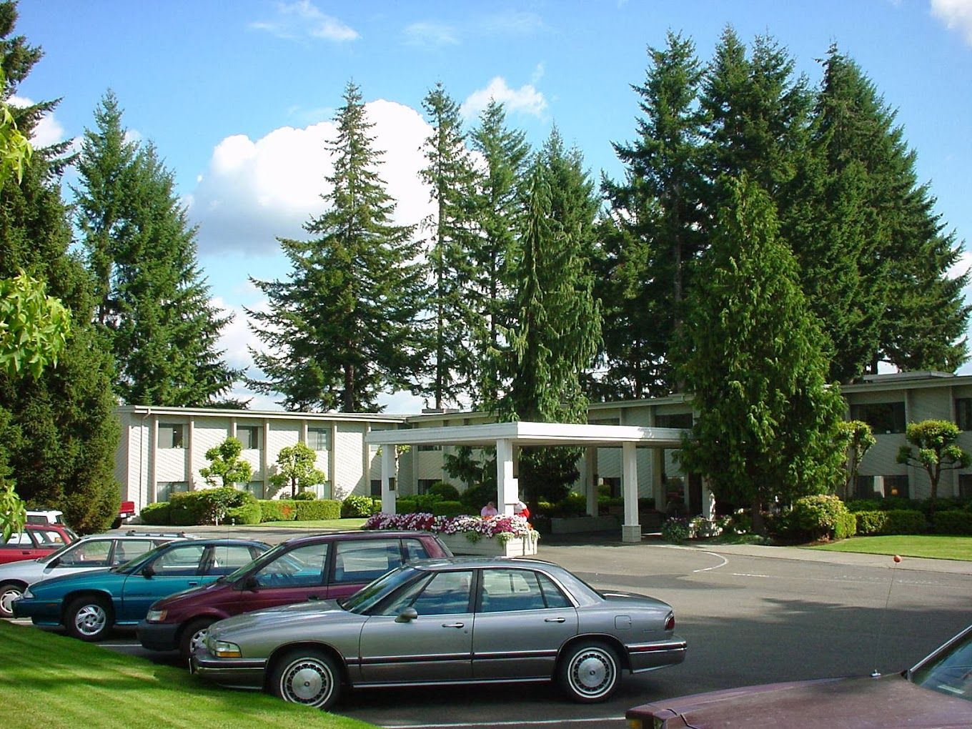 Exterior view of the facility with parked cars and trees
