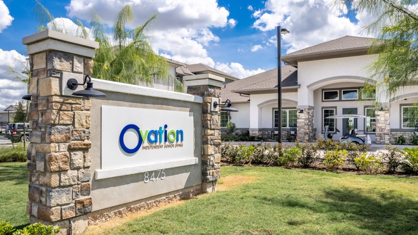Exterior view of the Ovation Independent Senior Living Apartments sign and building