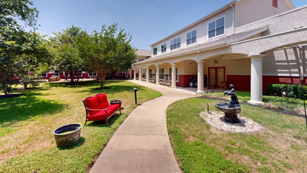 Pathway through a landscaped courtyard with seating