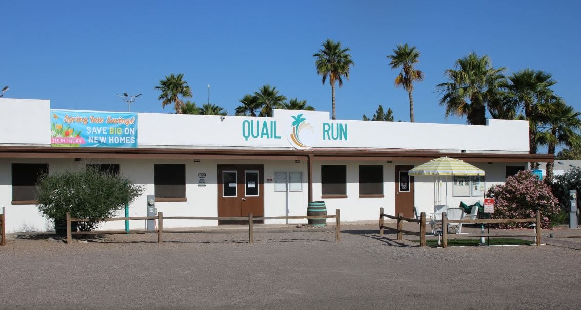 Exterior view of Quail Run facility with palm trees