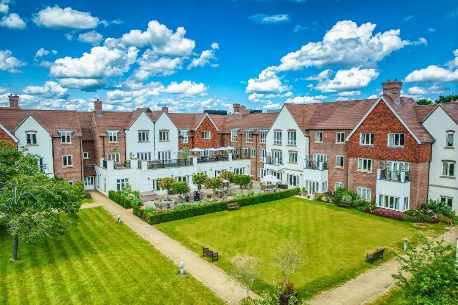 Aerial view of a senior living campus with outdoor gardens