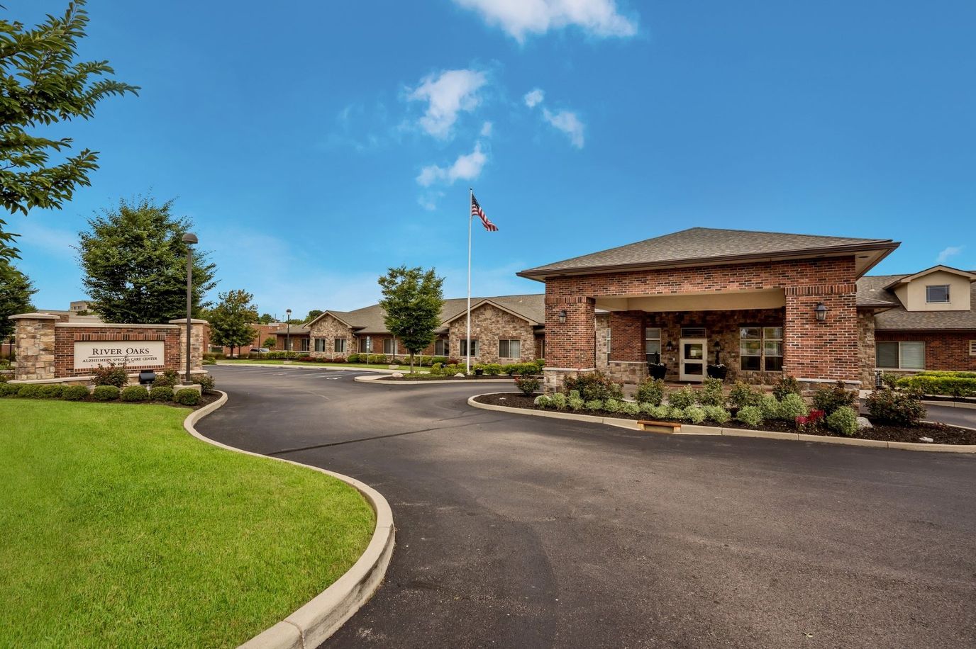 Exterior view of River Oaks with landscaped entrance