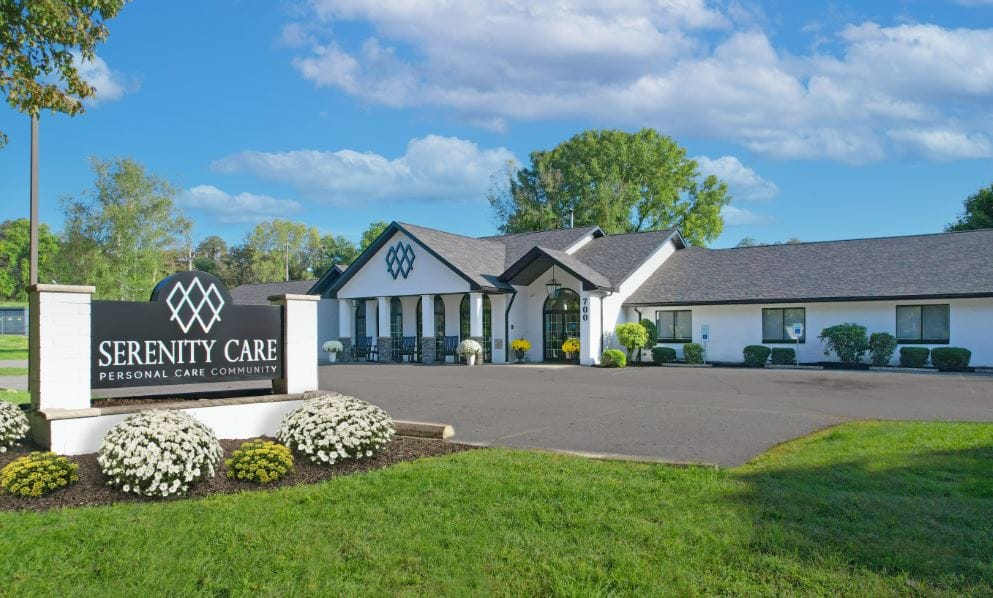 Exterior view of Serenity Care facility with landscaped entrance