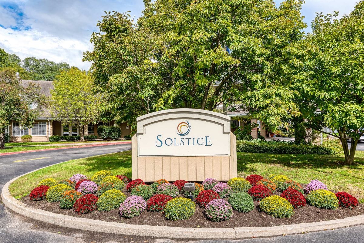 Logo of Solstice Senior Living at Fairport surrounded by flowers
