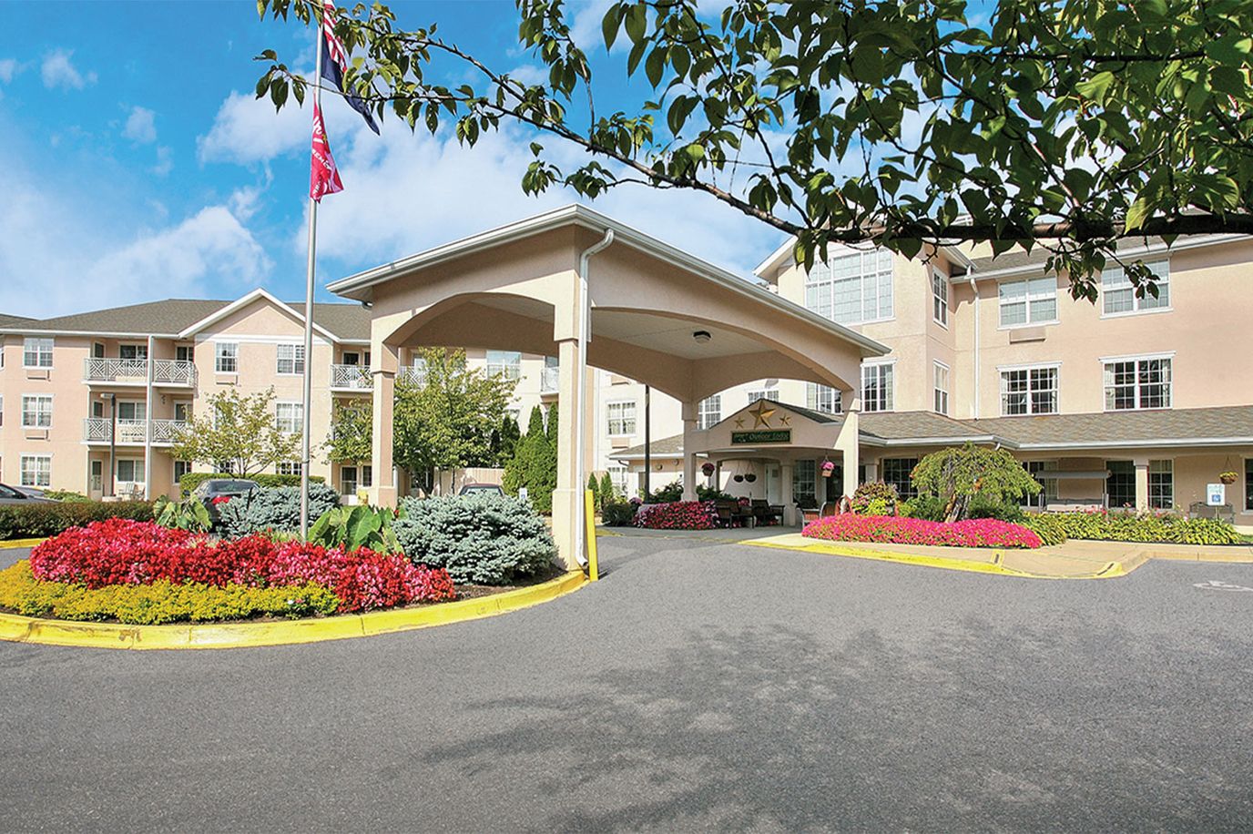 Front entrance of the facility with colorful landscaping