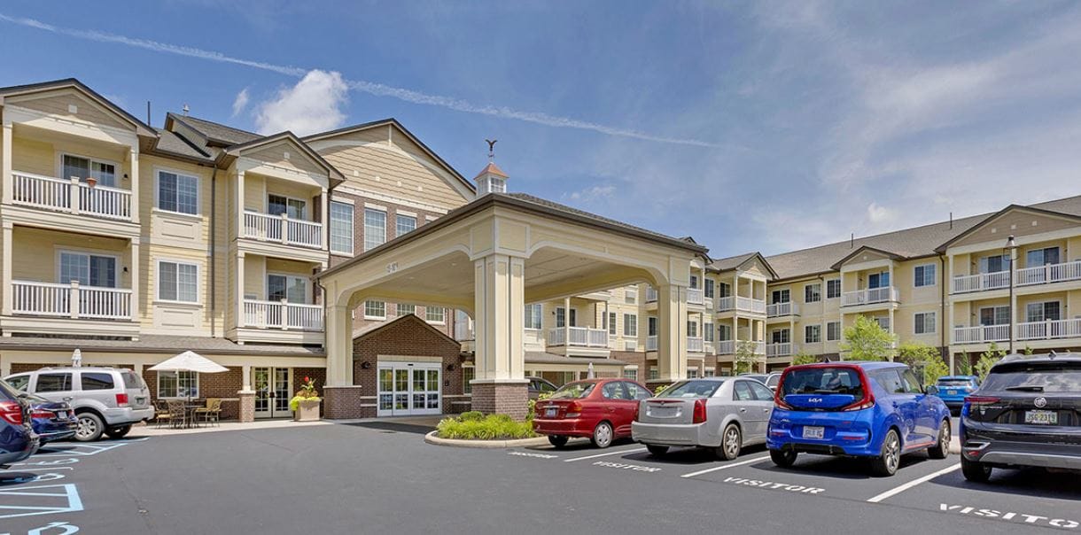 Front entrance of a senior living facility with parking