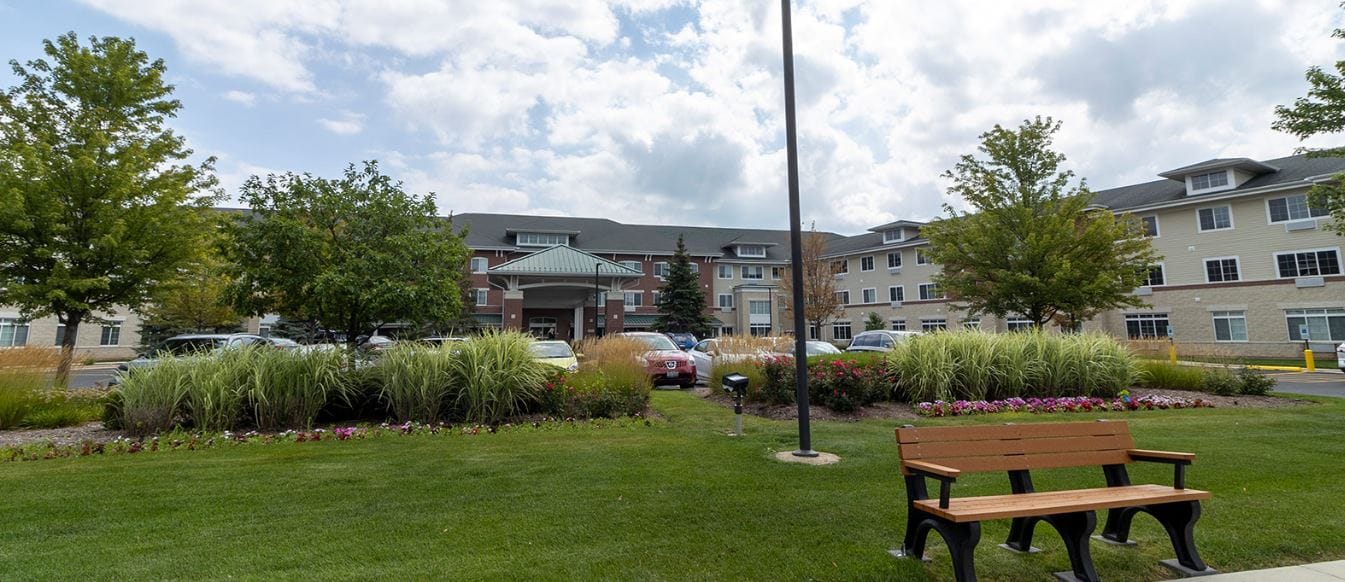 Exterior view of StoryPoint Romeoville with landscaped garden