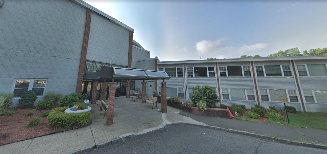 Exterior view of Tappan Zee Manor with seating area