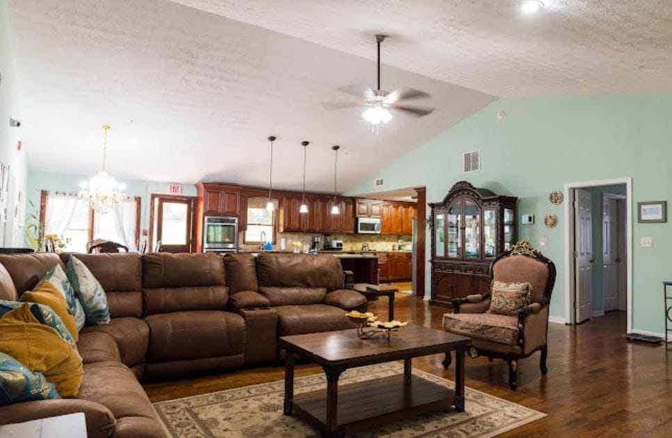 Bright common area with comfortable seating and kitchen view