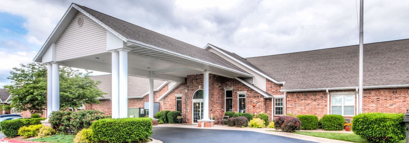 Exterior view of the facility entrance with landscaped gardens
