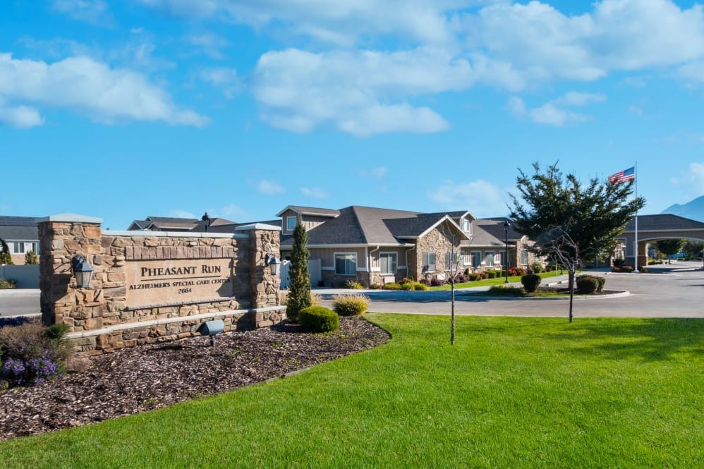 Exterior view of assisted living facility with sign