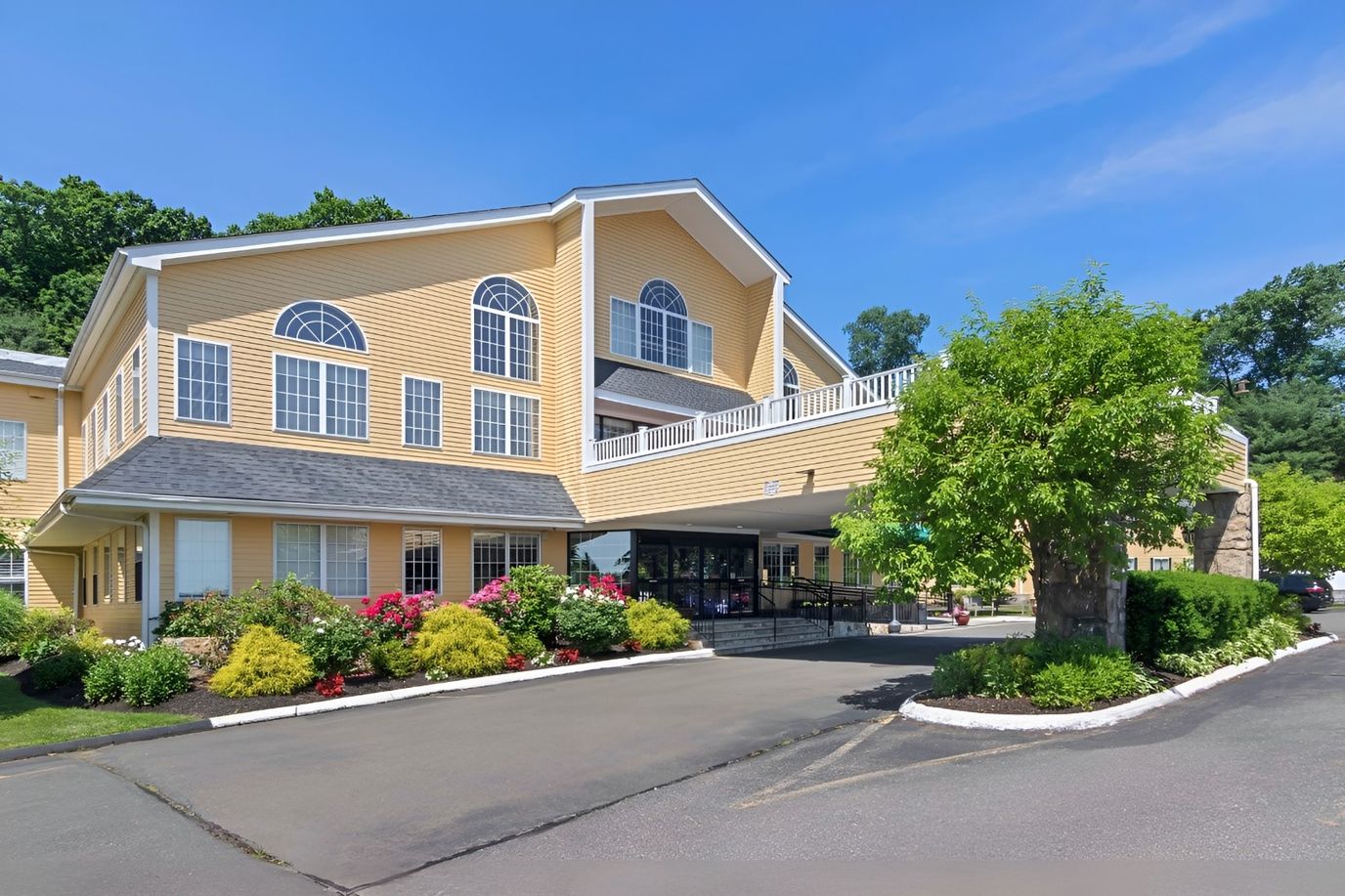 Exterior view of assisted living facility with gardens