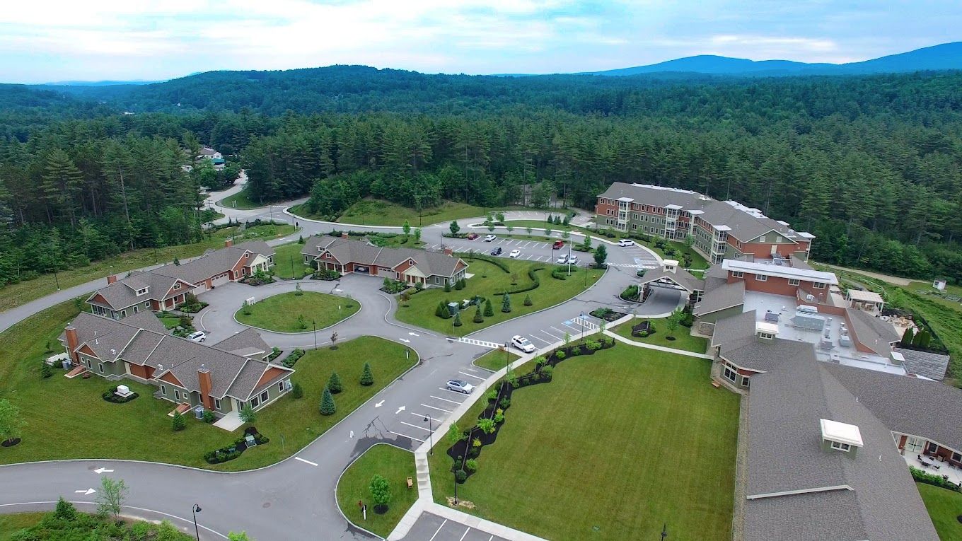 Aerial view of assisted living facility with landscaped grounds