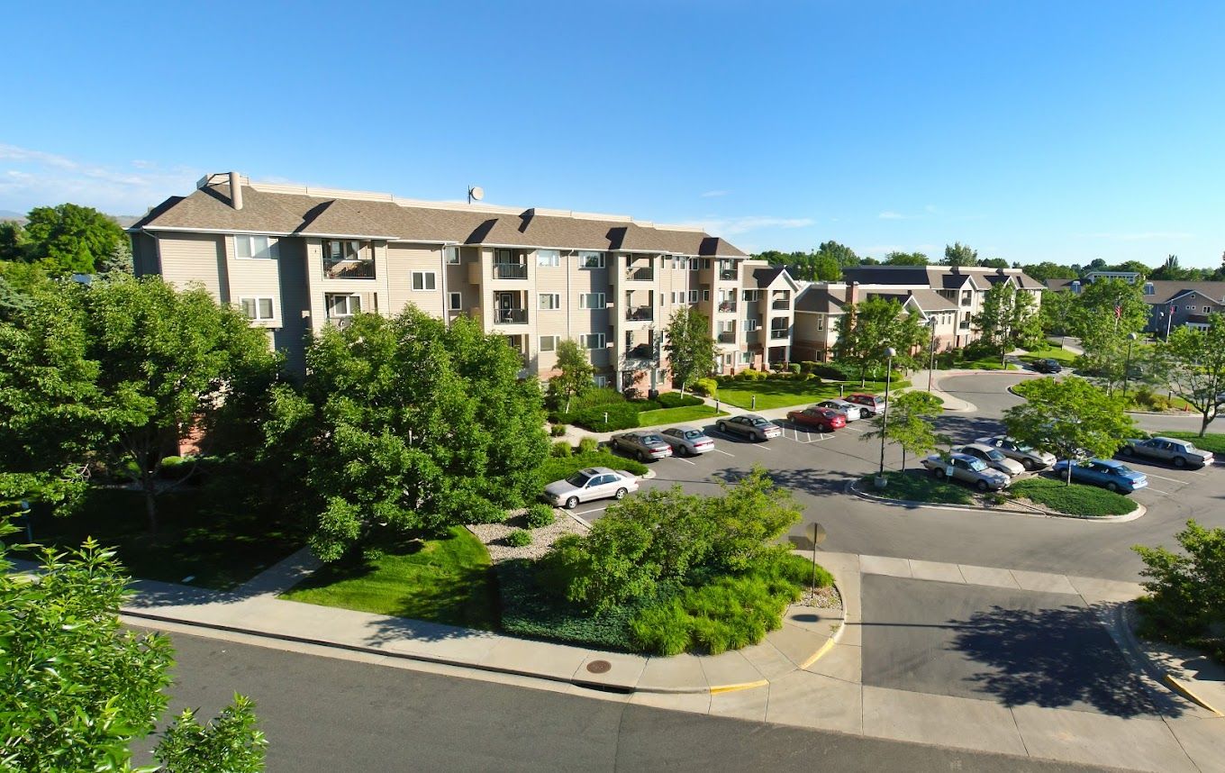 Exterior view of a senior living facility with landscaped grounds