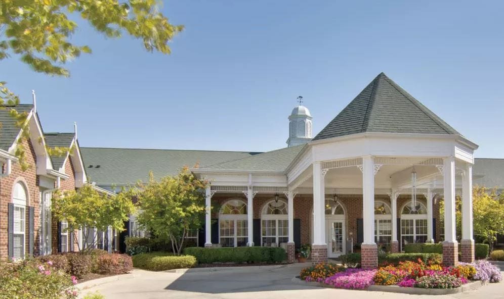 Exterior view of the facility with garden flowers