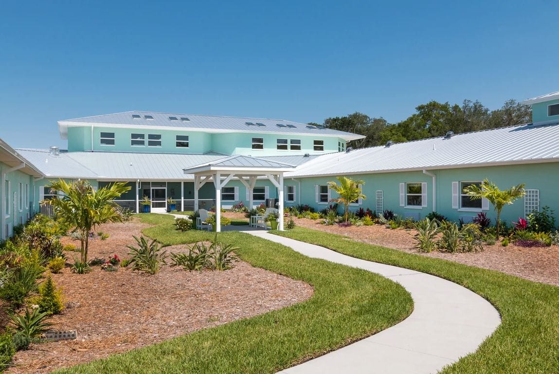 Exterior view of a well-kept assisted living facility garden
