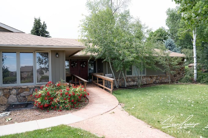 Exterior view of a senior living facility with gardens