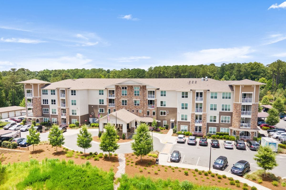 Aerial view of a senior living facility surrounded by greenery