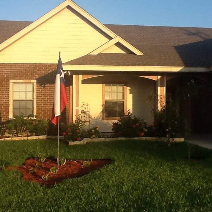Exterior view of a senior living facility with Texas flag