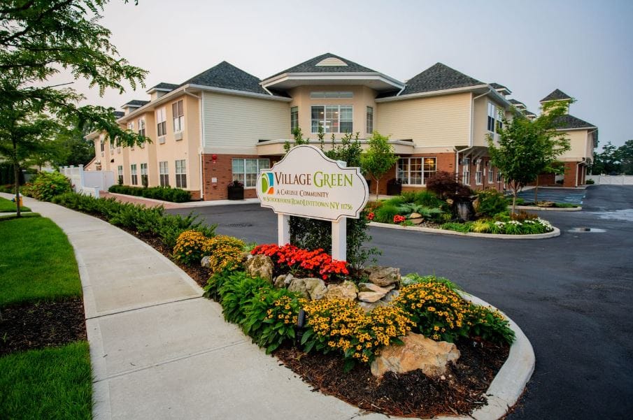 Exterior view of Village Green Senior Living facility