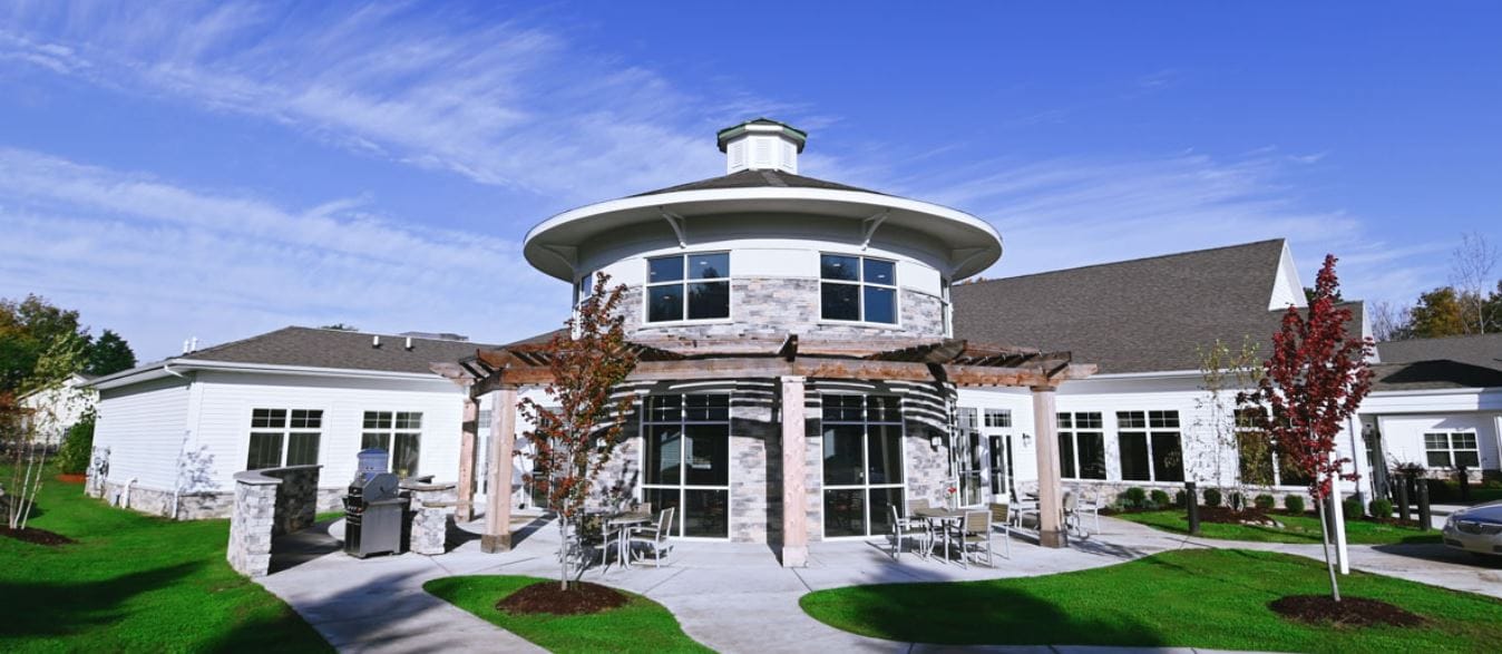 Exterior view of the facility surrounded by landscaped gardens