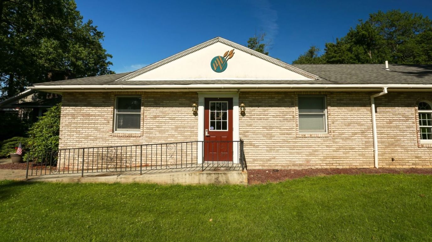 Exterior view of the facility building with a well-maintained lawn