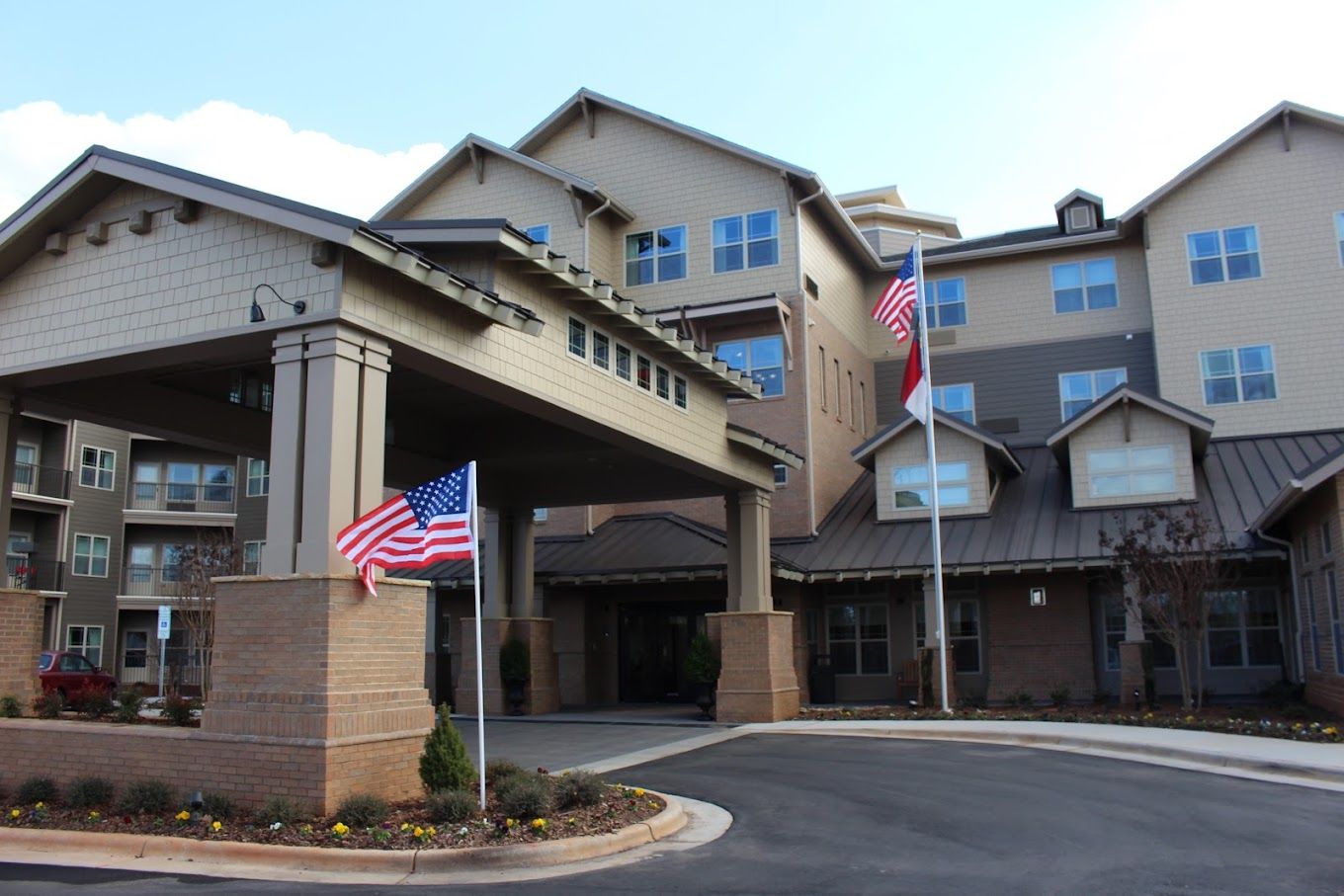 Front entrance of Williams Place facility with flags