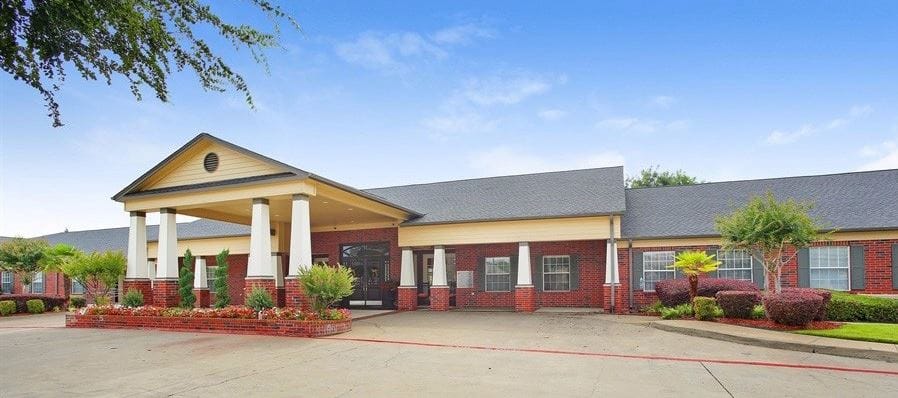 Exterior view of Bedford Estates Senior Living with landscaping