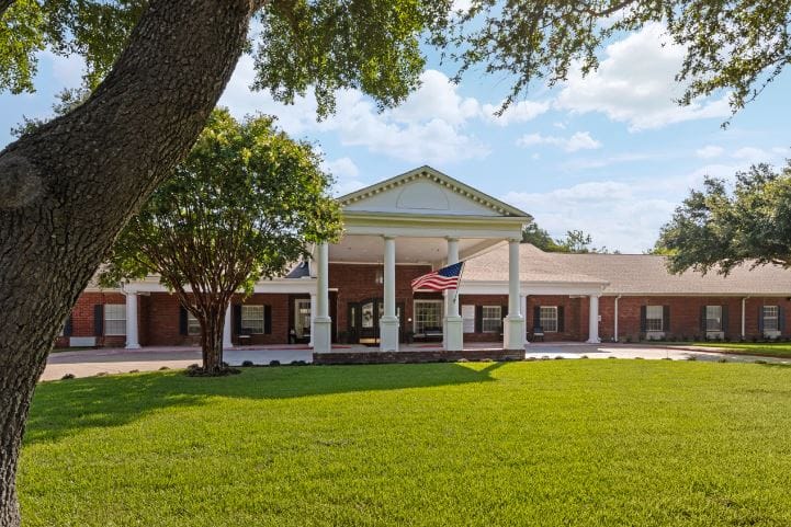 Exterior view of Carver Heights Estates with a flag