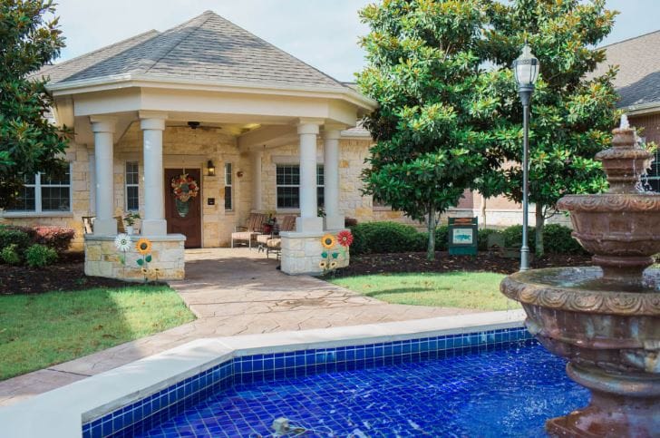 Charming entrance of a senior care facility with fountain