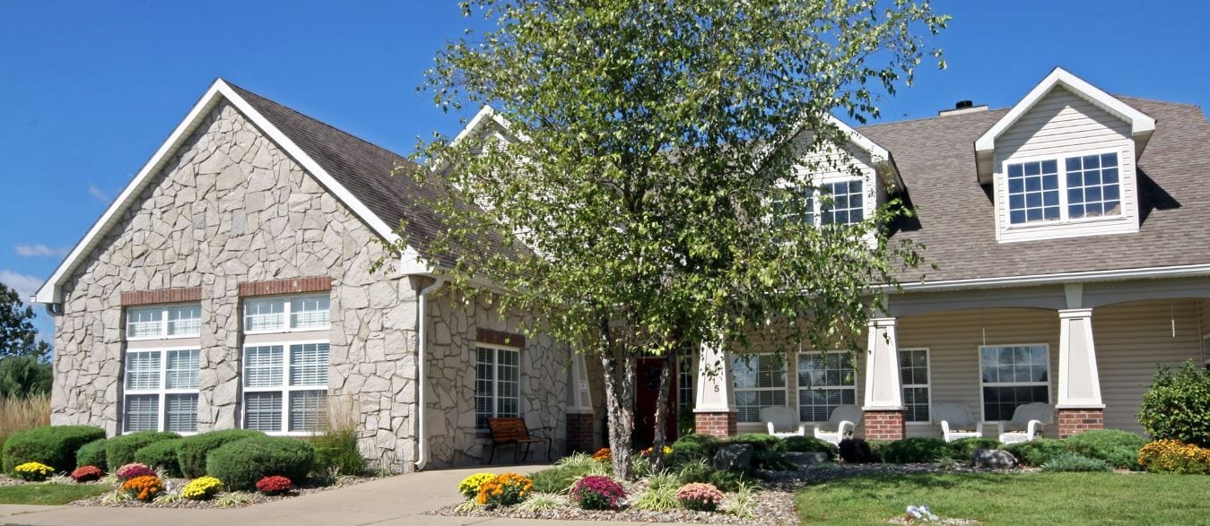 Exterior view of a senior living facility with landscaping