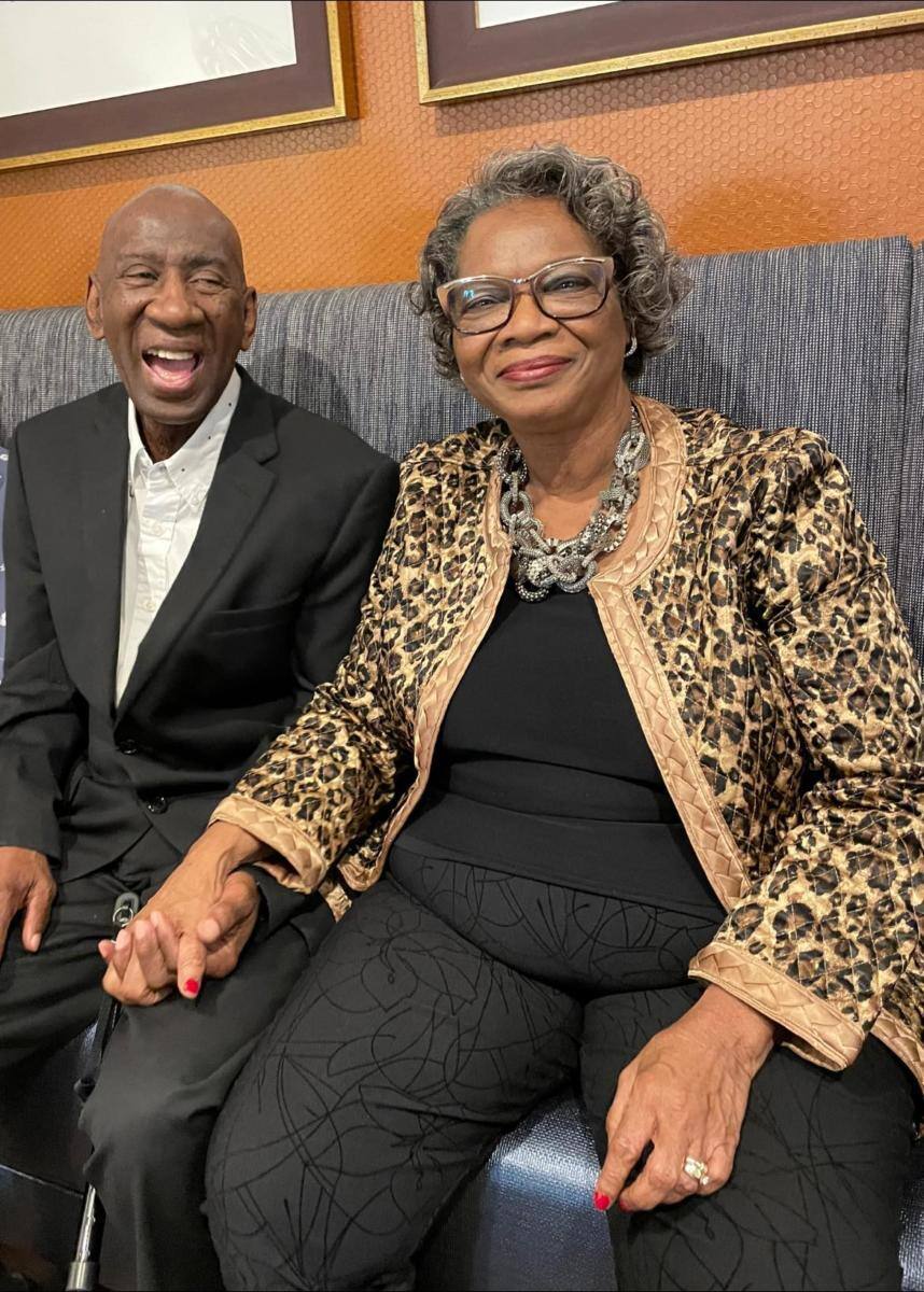 Two smiling residents enjoying time together in a common area
