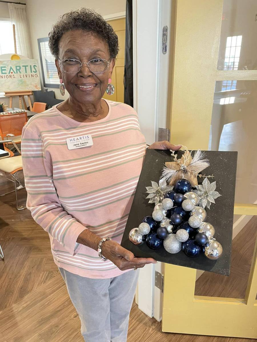 Resident presenting a holiday decoration in a common area