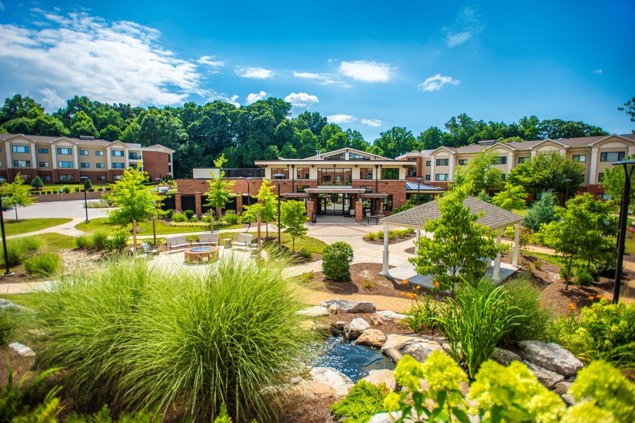 Exterior view of the facility with landscaped gardens