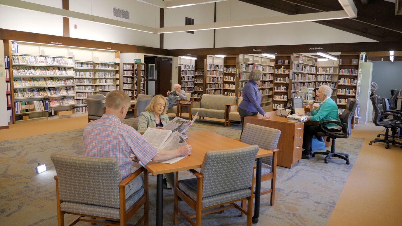 Residents engaging in activities in a library area