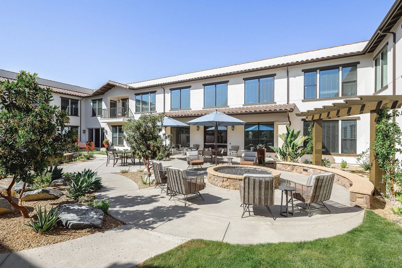 Outdoor patio area with seating and landscaping